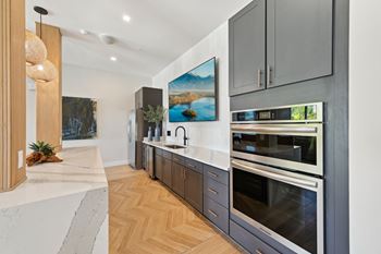 A modern kitchen with a marble countertop and stainless steel appliances. at The Concord Luxury Apartments, Sarasota, FL, 34240